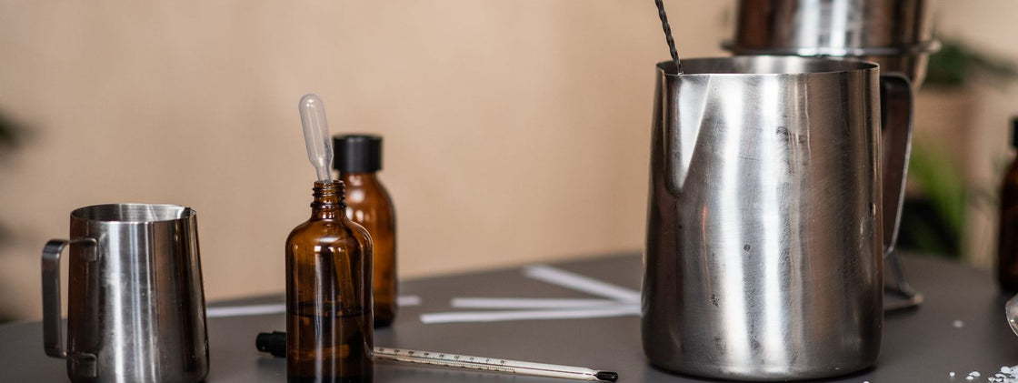 Fragrance oils, thermometer and pouring jugs on the bench at the Henry & Co Ashbourne workshop